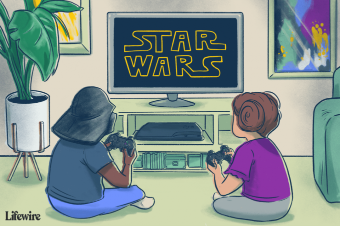 Dos niños jugando al videojuego Star Wars en una PlayStation 3, uno tiene un casco de Darth Vader y el otro tiene moños de princesa Leia