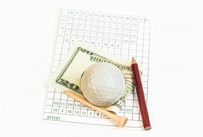Scorecard de golf și bani câștigați într-un joc de pariuri pe golf