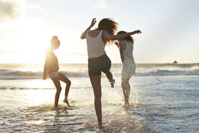ผู้หญิงสามคนบนชายหาดกำลังสนุก