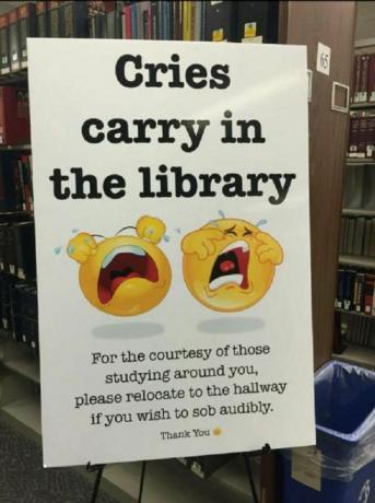 Znak, prikazan v knjižnici z besedilom, ki se glasi: V knjižnici nosijo joki. Zaradi vljudnosti tistih, ki študirajo okoli vas, se prosim premaknite na hodnik, če želite slišno jokati. Hvala vam."