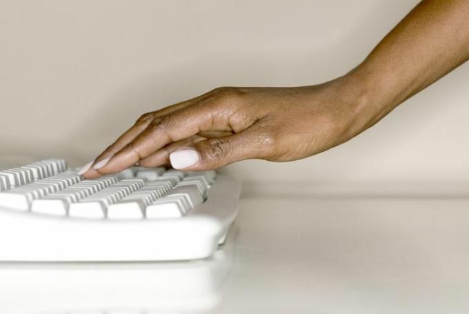 Ręka kobiety na klawiaturze komputera