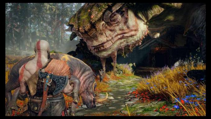 Kratos se acerca a una tortuga gigante mientras carga un jabalí en " God of War".